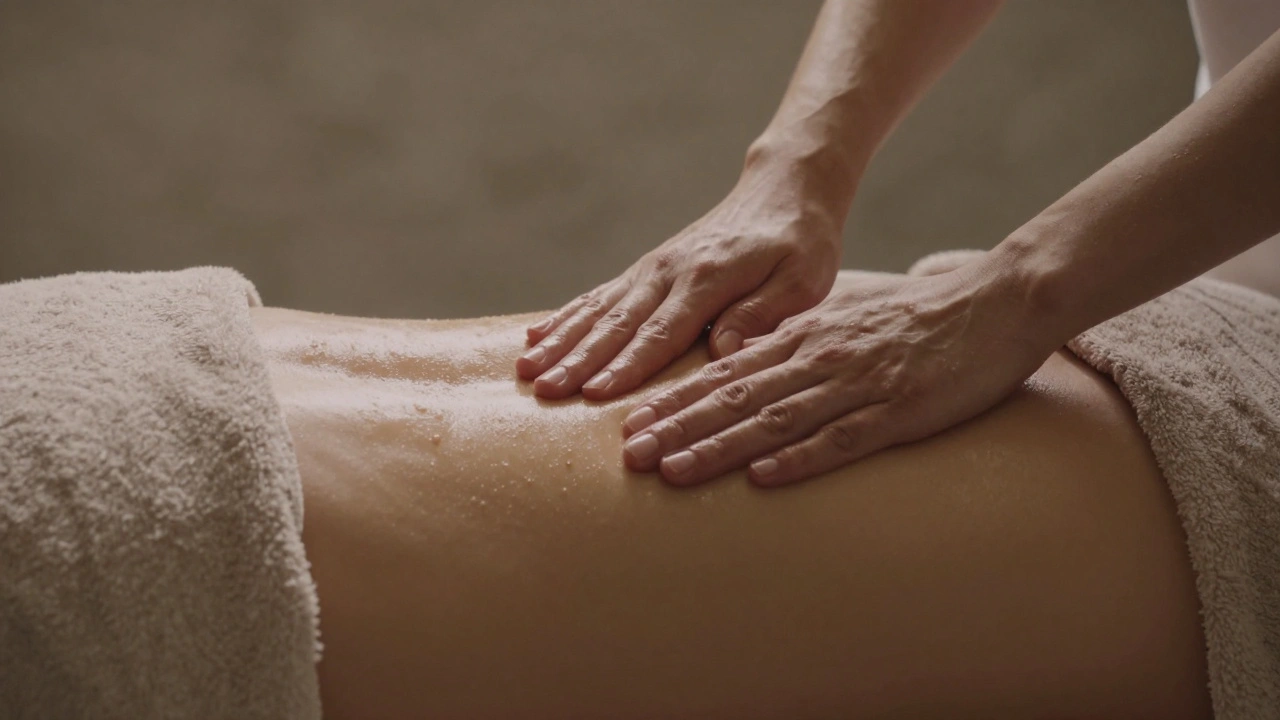 Gentle hands applying warm oil to a back covered by a soft towel.