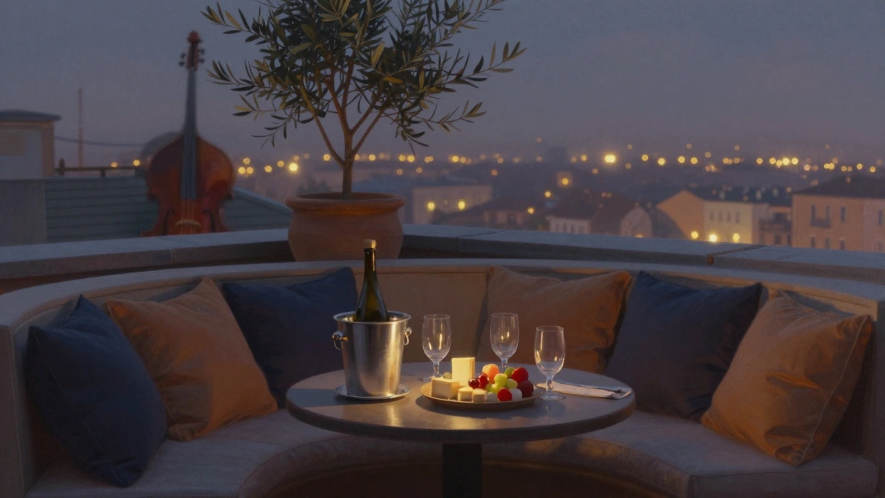 A cozy rooftop nook with a curved banquette, wine bottle, and cheese platter, bathed in warm twilight glow.