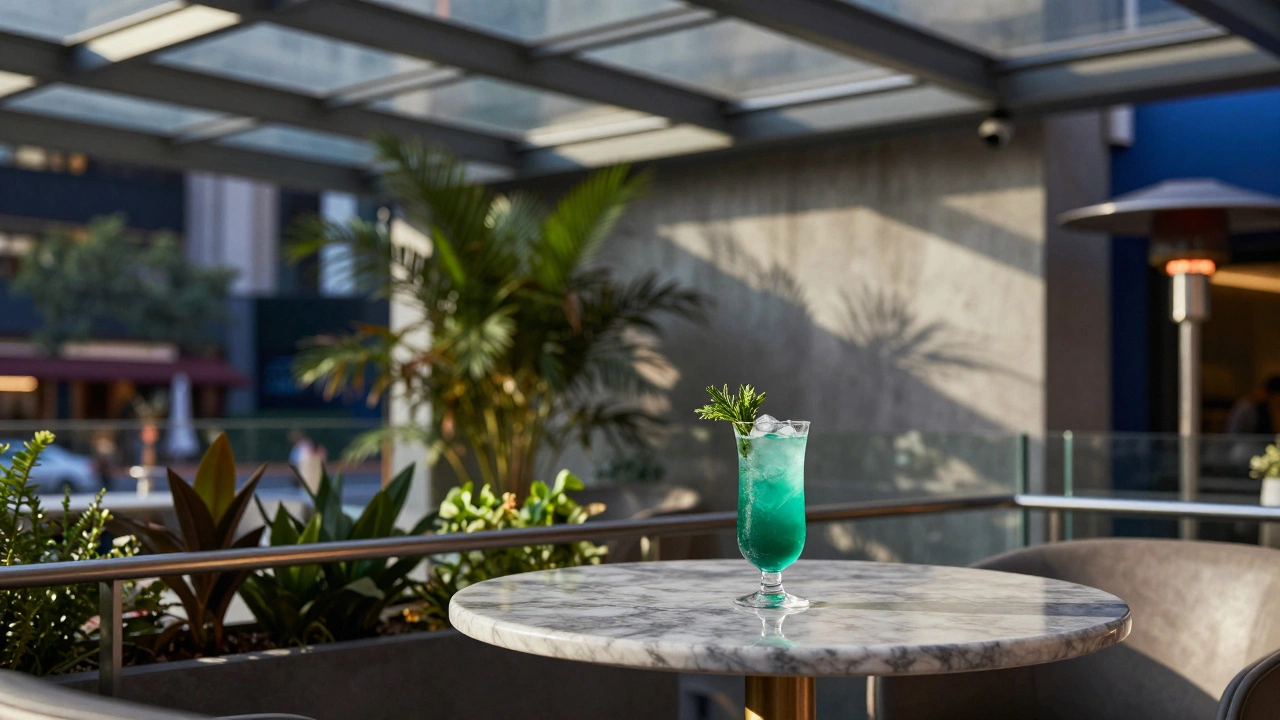 Cocktail on marble table with city view and heater in background.